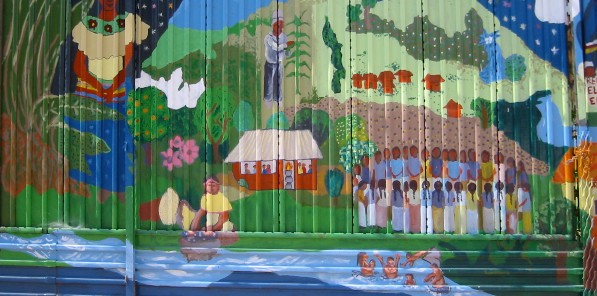 "Life and Dreams of the Perla Ravine" ("Vida y Sueños de la Cañada Perla"), originally by Sergio Valdez and community members in 1998. Repainted on the U.S. border wall in Nogales, Mexico in 2005 by Alberto Morackis, Guadelupe Serrano, and community members. Photo: Mary Watkins.